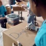 How to get holiday-ready and fundraise at the same time close up of woman marking donation boxes while vol 2022 11 16 14 40 42 utc