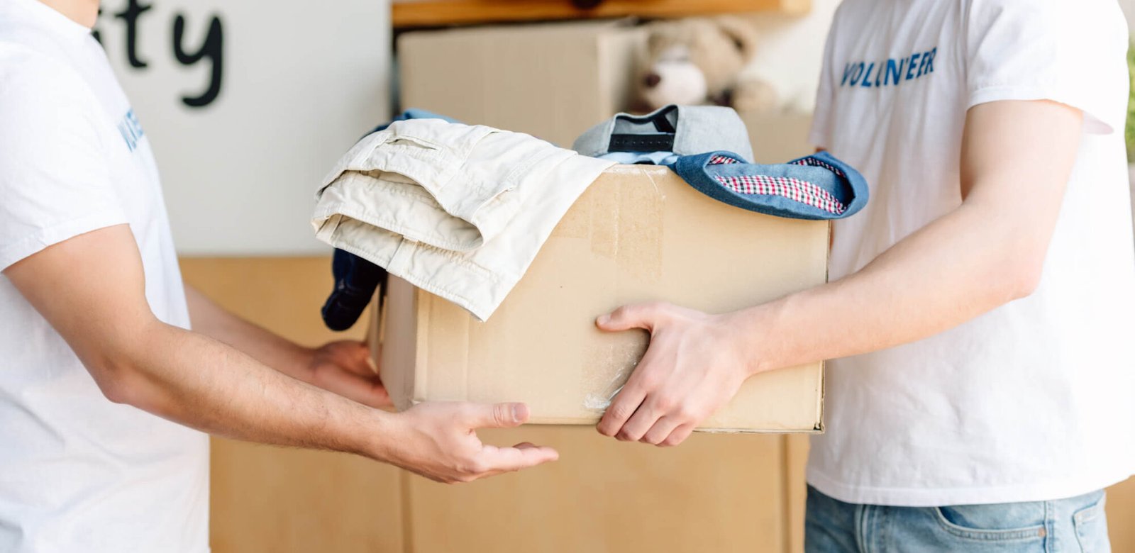 Want a chance to win big for your charity, then come on into spin to win! cropped view of volunteers holding cardboard box w k26fgnd